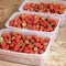 Strawberries in containers. Tasty berry. Red strawberry