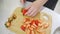 strawberries are cut into pieces on a wooden cutting board to decorate desserts.