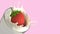 Strawberries floating on milk