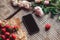 Strawberries, flowers and phone on the rustic table.