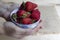 Strawberries in hands on a wooden background. Strawberry season. Yummy