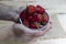 Strawberries in hands on a wooden background. Strawberry season. Yummy