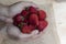 Strawberries in hands on a wooden background. Strawberry season. Yummy