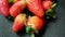 Strawberries isolated on a table with dark tablecloth