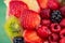 Strawberries, kiwi, currants, raspberry, pineapple, blackberry. Delicious dessert. Soft focus. Closeup. Top view