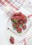 Strawberries on a light background with sour cream