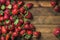 Strawberries over natural wooden background