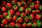 Strawberries pile in wooden box