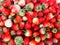 A strawberries piled on the background, fresh piles of strawberries sold on the market for fresh fruit in the winter, The fresh st