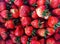 A strawberries piled on the background, fresh piles of strawberries sold on the market for fresh fruit in the winter, The fresh st