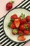 Strawberries in a plate. Styled summer fresh berries. Pink background, flat lay
