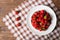 Strawberries on the plate and on the tablecloth