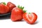 Strawberries on plate on white background