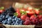 Strawberries, raspberries, blueberries, blackberries on a separate dish close-up on a solid concrete background. Healthy eating