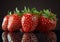 Strawberries on a reflective surface minimalist black background