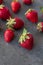 Strawberries ripe on a dark black beton background.