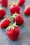 Strawberries ripe on a dark black beton background.