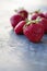 Strawberries ripe on a dark black beton background.