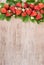 Strawberries on rustic background with text space. Vertical image