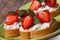 Strawberries sandwiches with cream cheese and mint closeup