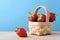 Strawberries in Small Basket with Blue Background