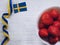 Strawberries and Swedish flag on white background