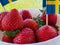 Strawberries and Swedish flags for celebration of Swedens National Day or Midsummer.
