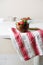 Strawberries in wooden bowl on dishtowel, red and white stripes
