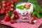 Strawberries yogurt with fresh fruits on red checkered napkin