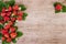 Strawberry arrangement over light wooden background with text space