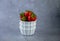 Strawberry berries in a white bowl on a concrete table. Place for text. Strawberries in a plate - dessert. Healthy food. Breakfast