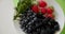 Strawberry, blackberry and fresh mint leaves on the plate. Fresh organic healthy fruits. Top view