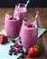 Strawberry-blueberry cocktail served in a glass, decorated with fresh berries and strawberries.