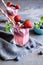 Strawberry and blueberry smoothie with yogurt, decorated with fruit skewer