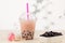 Strawberry Boba Bubble Tea with candy and crushed ice.