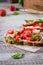 Strawberry bruschetta with cottage cheese,basil and strawberry on baking paper