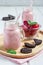 Strawberry cheesecake smoothie with cream cheese and milk, served with chocolate cookies