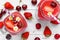 Strawberry and cherry smoothie in glass jars with straw and fresh fruits and berries