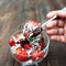 Strawberry with chocolate eating, wooden backdrop