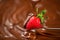 Strawberry in chocolate. Melted chocolate pouring on fresh ripe juicy strawberry closeup over swirl brown background. Fondue