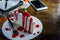 strawberry crape cake on wood table in coffee shop , dessert tasy cake