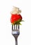 Strawberry with cream on a fork macro isolated