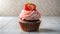 Strawberry cupcake with pink frosting. Front view