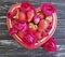 Strawberry dish heart, flower rose summer festive design dessert on colored wooden background