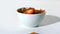 Strawberry falling in a wheat cereals bowl