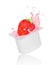 Strawberry falling into yogurt splash in plastic packing