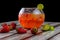 Strawberry flavored drink served in a large fishbowl on a table in restaurant