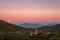 Strawberry full moon rising over mountains of Corsica