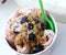 Strawberry ice roll sundae with granola, berries and coconut