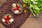 Strawberry jam with berries and muesli tea. Against the background of wildflowers. Wooden rustic table. Top view